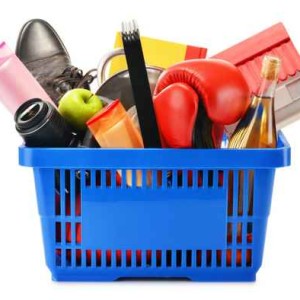 Variety of consumer products in plastic shopping basket isolated